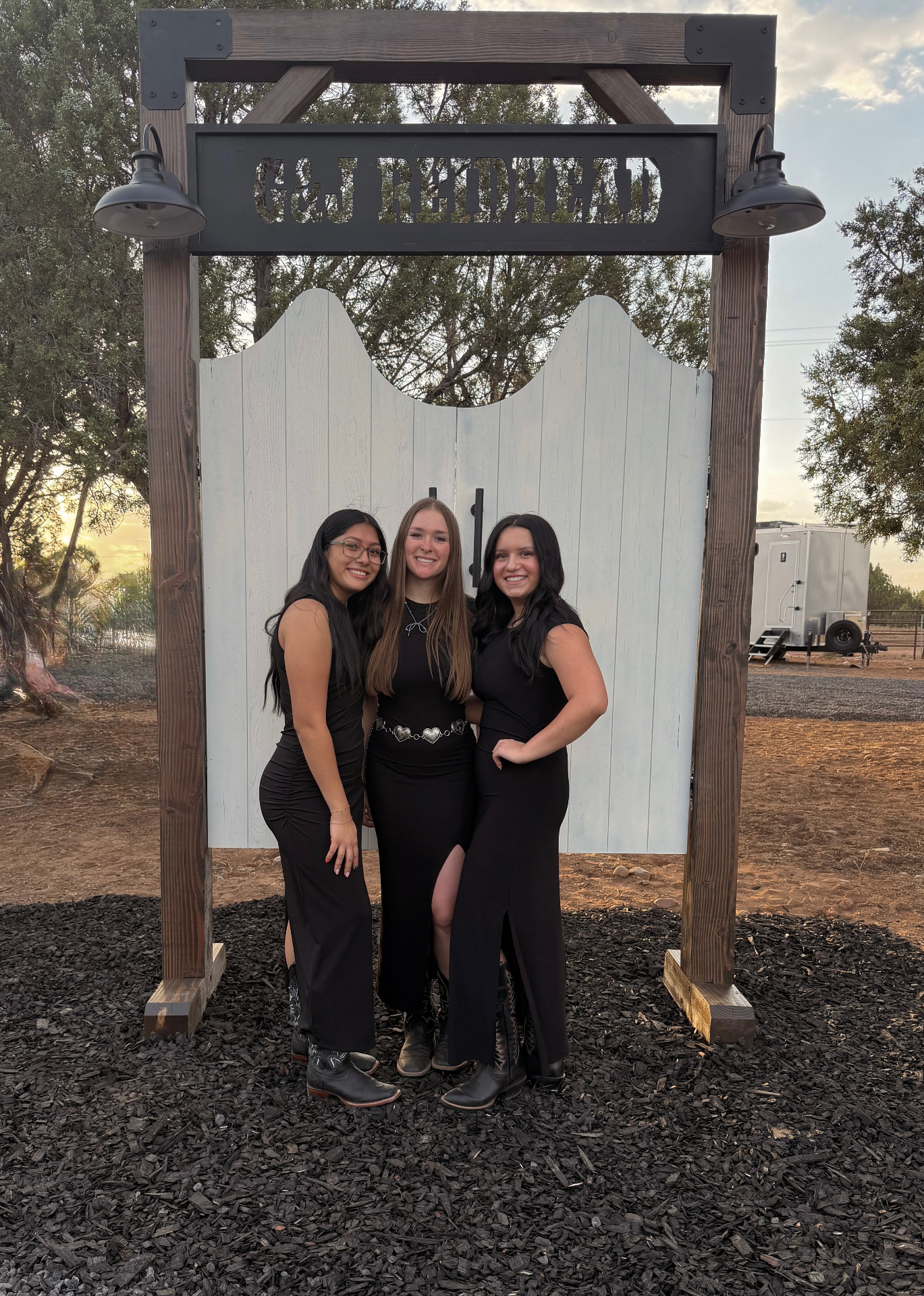 Outdoor Arizona wedding ceremony with bridal party seated on Borrow Bloom handcrafted white pews