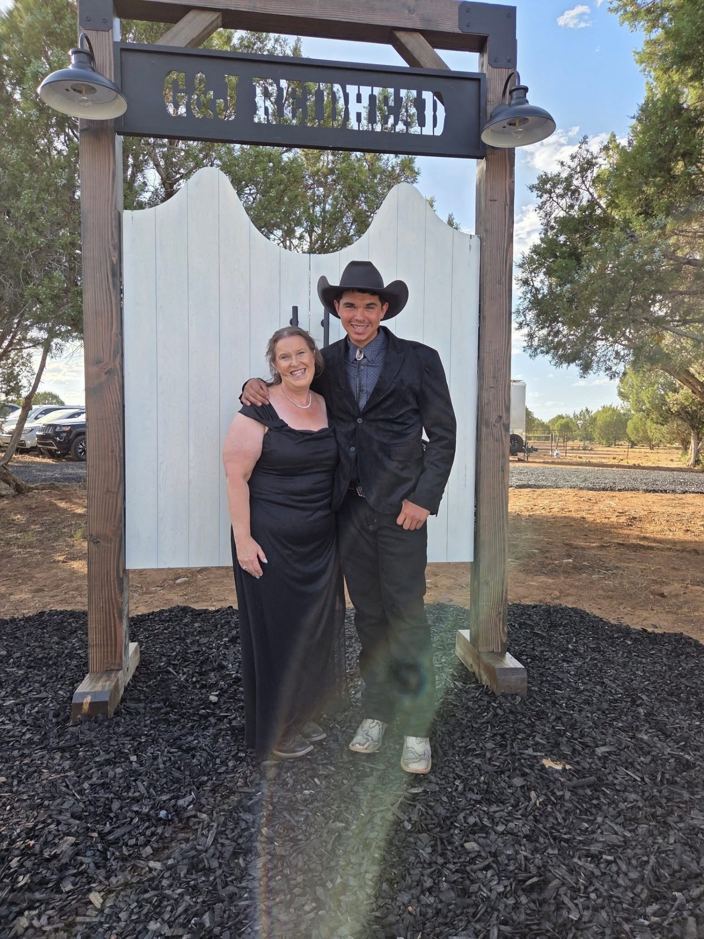 Ortega family Arizona wedding ceremony with vintage saloon doors and Borrow Bloom pew rentals